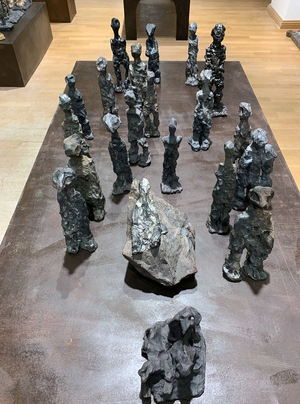 Wilhelm Moser - Vagabonds de l'âme, 2021 - Tableau de 33 figurines en terre cuite sur table industrielle en acier (10 à 31 cm)